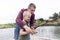 Father and son fishing. Dad shows his son how to hold the spinning and spin the reel. Fishing training on a pond or river. Caring