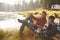 Father and son fishing by a lake, dad looks to camera