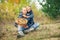 Father and son with full basket of mashrooms on the forest glade