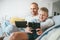 Father and son game players funs sit together at home on cozy so