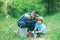 Father and son gardening. Little son helping his father to plant the tree while working together in the garden.