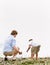 Father and son gathering rocks at beach