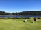 Father and son golfing surrounded by lakes and forest on a beautiful summer day along the sunshine coast, British Columbia