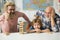 Father and son with grandfather was excited with playing game. Father and son playing Jenga with grandchild.