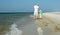 Father and son hand in hand are walking along the sand beach at sea as a concept of parenthood and parenting