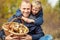 Father and son are happy that they have found a basket full of mushrooms