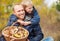 Father and son are happy that they have found a basket full of mushrooms