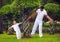 Father and son having fun in oriental bonsai garden