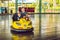 Father and son having a ride in the bumper car at the amusement