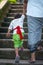 Father and son hold hands and climb the stairs. Indonesian culture. Island of Bali. Close up