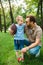 father and son hugging and holding american football ball