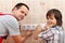 Father and son installing electrical wall fixtures