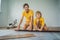 Father and son installing new wooden laminate flooring on a warm film floor. Infrared floor heating system under