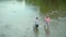 Father and son ishing. Fly fisherman using fly fishing rod in beautiful river. Family and generation - summer holidays