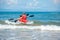 Father and son kayaking in ocean. Active vacation with young kid. Holiday activity with schoolboy child