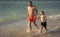 Father son kid bonding relationship. daddy and son running in sea beach. Father son child bonding enjoying summer