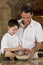 Father and Son In Kitchen Cooking Baking Cookies