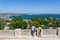 Father and son look at a summer landscape with a view of the sea port