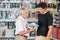 Father And Son Looking At Drill In Store