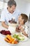 Father And Son Making Fresh Vegetable Juice