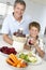 Father And Son Making Fresh Vegetable Juice