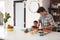 Father And Son Making School Lunch In Kitchen At Home