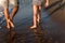 Father and son, man & boy child, running and having fun in the sand and waves