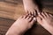 Father and son measuring their feet on wooden background