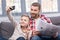 Father and son with newspaper and smartphone