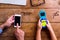 Father and son, office desk, working on smart phones