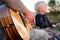 Father and Son Outside PLaying Guitar and Singing