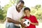 Father And Son In Park With Soccer Ball