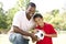 Father And Son In Park With Soccer Ball