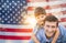 Father with Son Piggy Back Riding In Front of American Flag