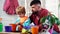 Father and son plantig plant in pots. Daddy teaching little boy to do gardening.