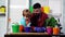 Father and son plantig plant in pots. Daddy teaching little boy to do gardening. Family planting.