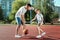 Father and son play basketball together at the basketball court. father spends time with the child, sporty lifestyle, training,