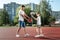 Father and son play basketball together at the basketball court. father spends time with the child, sporty lifestyle, training,