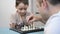 Father and son play chess and spend time together. Portrait of a happy child. A symbol of a happy family, fatherhood and