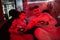 Father and son play gamepad video game console in red gaming room. Dad and kid gamers