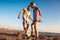 Father and son play soccer or football on the beach having great family time on summer holidays