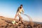 Father and son play soccer or football on the beach having great family time on summer holidays