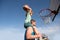 Father and son playing basketball. Happy father holding his little son on shoulders, helping him to score a basket on a
