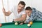 Father and son playing billiard