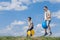 Father and son playing on the field at the day time.