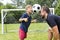 Father with son playing football on football pitch