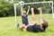 Father with son playing football on football pitch