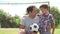 Father And Son Playing Football In Garden At Home