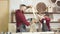 Father and son playing knights with wooden DIY swords at carpenter workshop