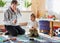 Father and son playing with racing cars on racetrack, indoors, t